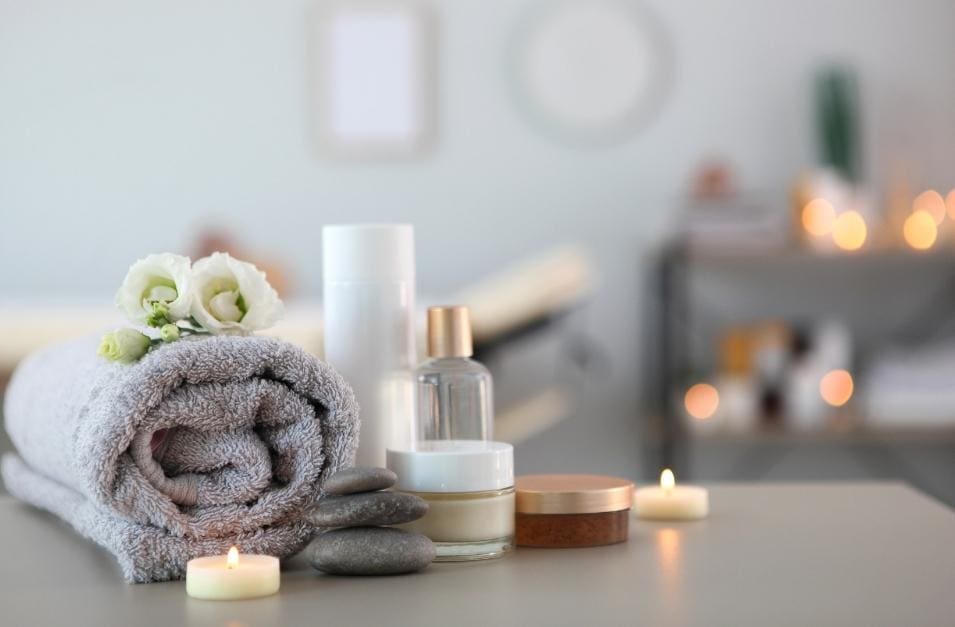A table with spa products and candles used for a business branding lesson at the spa.
